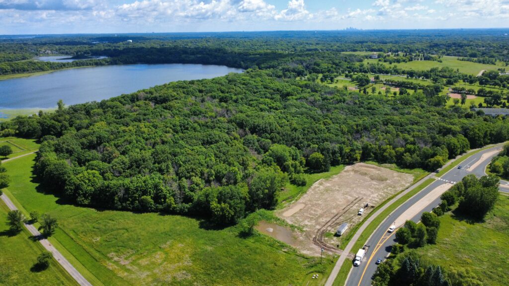 Aerial view of the Eden Springs site with the lake and surrounding woods